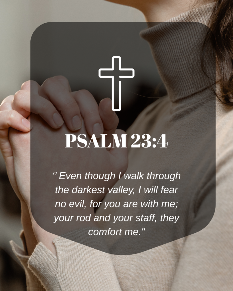 "Person praying with hands clasped showing Psalm 23:4 verse about God being always present in times of fear and walking through dark valleys"