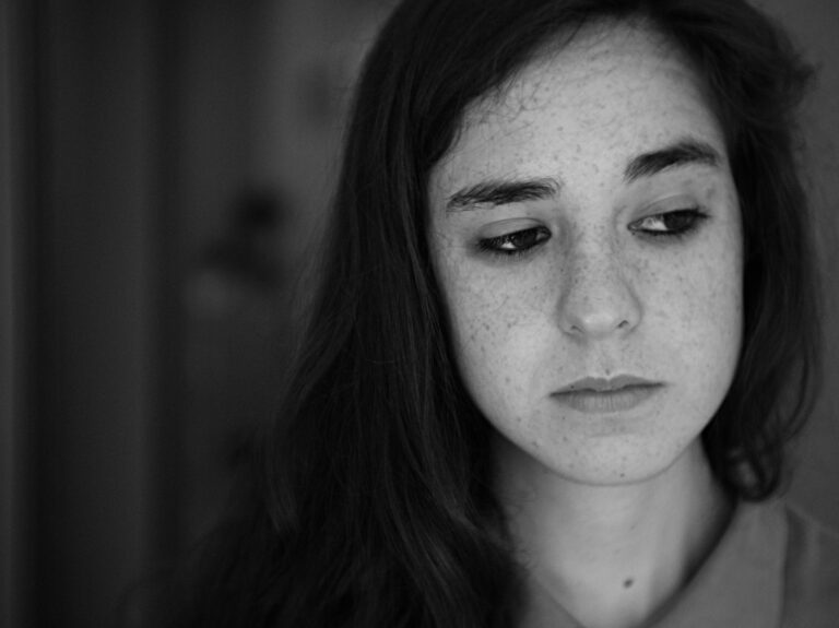"Young woman in contemplative black and white portrait representing overcoming fear and anxiety through bible verses and faith"